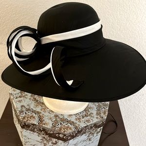 Black with white trim. A wonderful lady’s hat for church.
